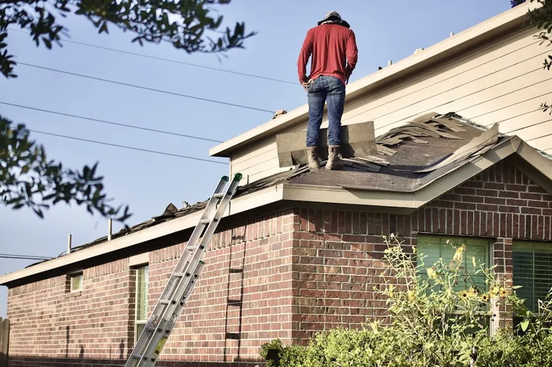 Professional roofer working on a residential roof in Madera